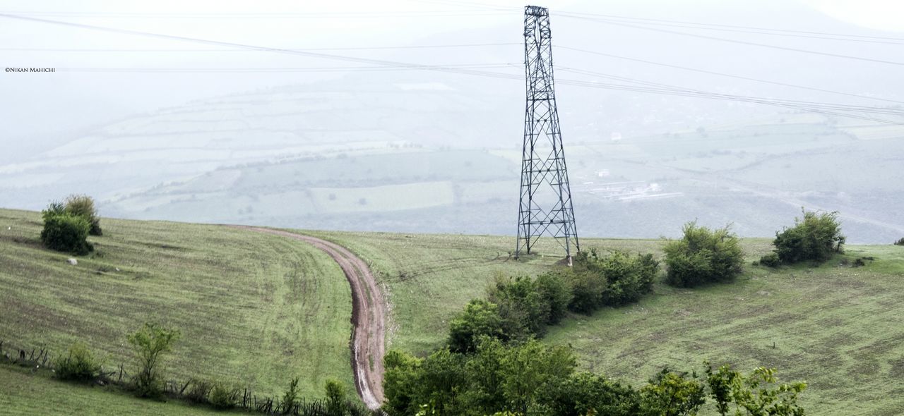 electricity pylon, power line, electricity, fuel and power generation, power supply, connection, cable, tree, technology, field, landscape, rural scene, tranquility, nature, tranquil scene, sky, growth, day, power cable, outdoors