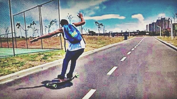 full length, lifestyles, leisure activity, casual clothing, sky, blue, road, childhood, person, street, boys, sport, cloud - sky, elementary age, standing, fun, motion, day