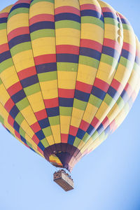 Low angle view of hot air balloon against clear blue sky