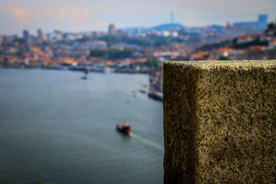 Close-up of retaining wall by sea against sky