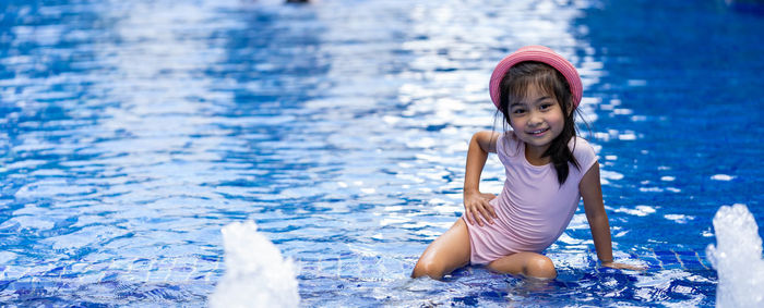 Portrait of smiling girl in water