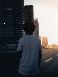 Rear view of man standing in city