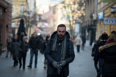 Portrait of young man standing on street