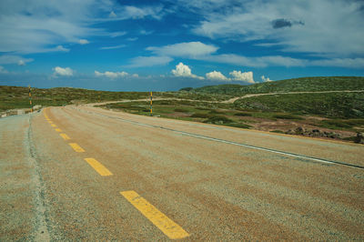 Long roadway passing through rocky landscape, at the highlands of the serra da estrela. portugal.