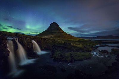 Scenic view of majestic mountains against sky at night