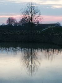 Scenic view of lake against sky at sunset