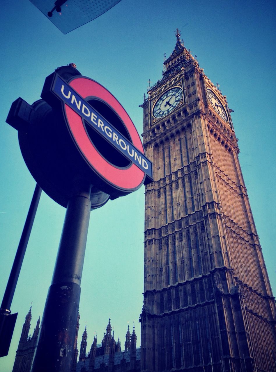 architecture, built structure, building exterior, low angle view, clear sky, tower, clock tower, famous place, tall - high, travel destinations, city, international landmark, capital cities, tourism, blue, travel, big ben, communication, clock, outdoors