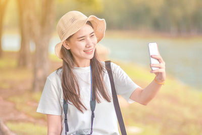 Mid adult woman using smart phone outdoors