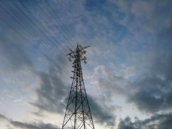 Low angle view of electricity pylon against sky