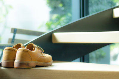 Close-up of shoes on window sill