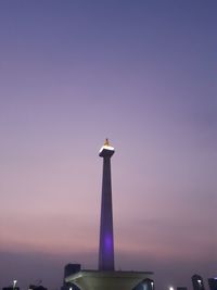 Low angle view of illuminated building against sky during sunset