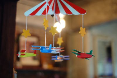 Close-up of multi colored flags hanging on table