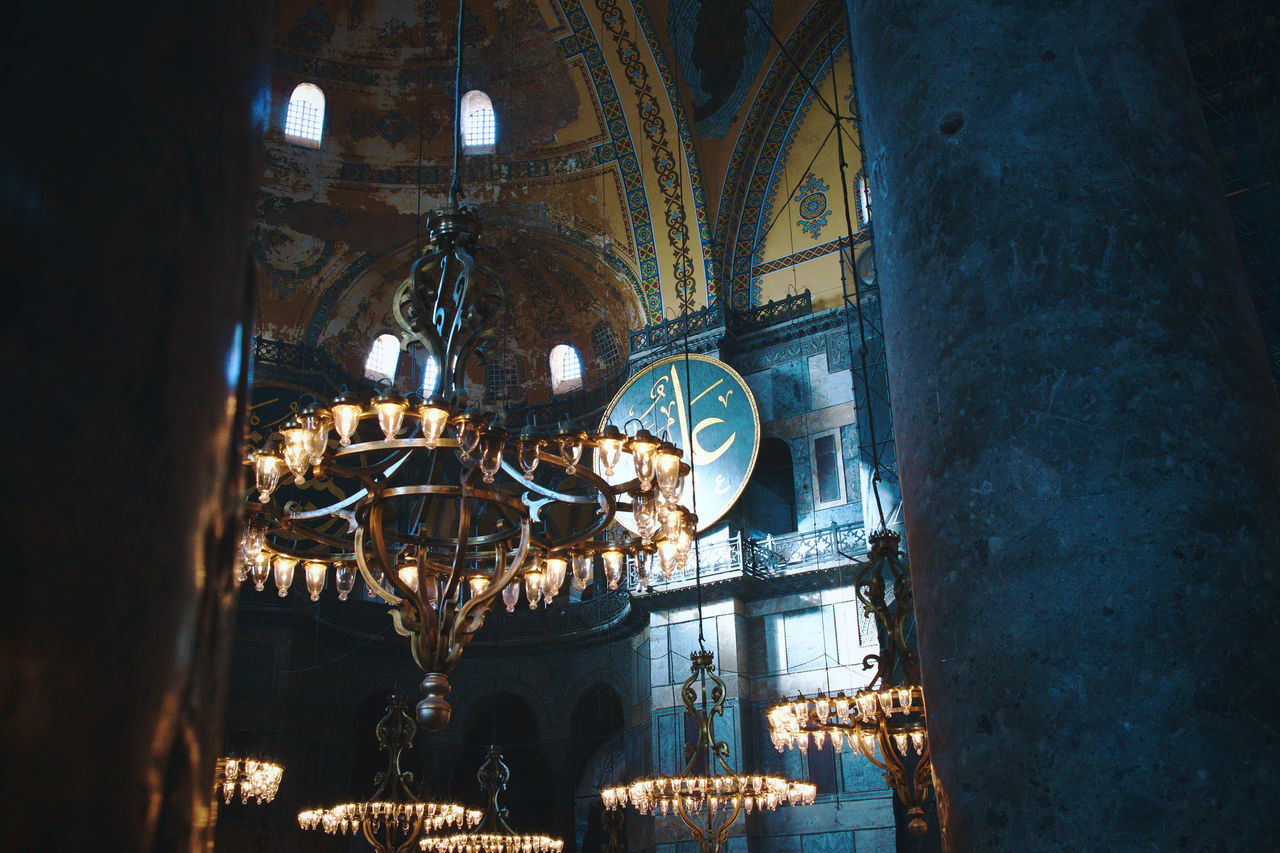 LOW ANGLE VIEW OF ILLUMINATED CEILING AND BUILDING AT HOME