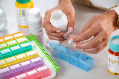 Cropped hand of woman holding pills
