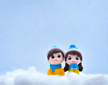 Close-up of stuffed toy against blue sky during winter