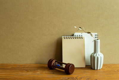 Close-up of objects on table against wall at home