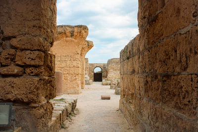 Old ruins of building against cloudy sky