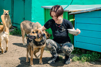 Dog at the shelter. animal shelter volunteer takes care of dogs. lonely dogs in cage with volunteer.