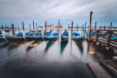 Boats moored in sea against sky