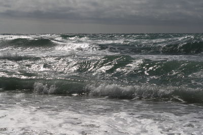 Scenic view of sea against cloudy sky