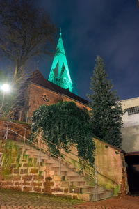 Illuminated building against sky at night