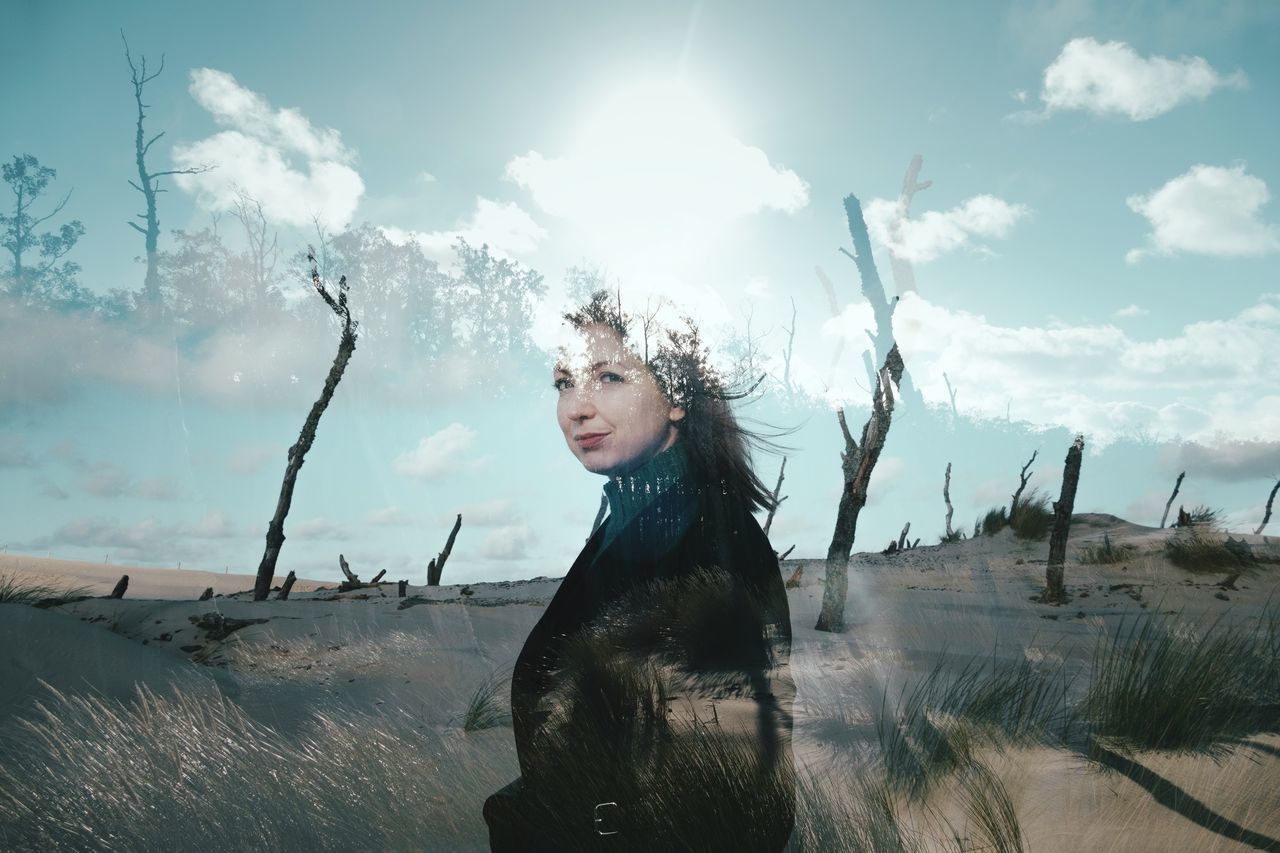 sky, land, cloud - sky, leisure activity, lifestyles, real people, young adult, women, one person, nature, young women, standing, adult, environment, day, field, plant, beautiful woman, hair, hairstyle, wind, outdoors, digital composite