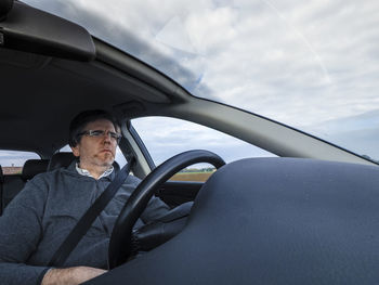 Man sitting in car