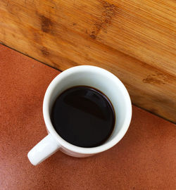 High angle view of black coffee on table