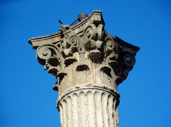 Low angle view of statue against blue sky