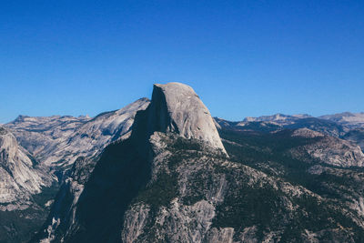 Scenic view of mountains against clear blue sky