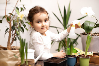 Portrait of cute girl blowing flowers