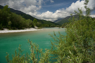 Scenic view of sea and mountains against sky