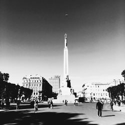 People in city against clear sky