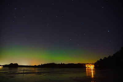 Scenic view of lake against sky at night