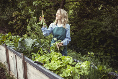 Woman standing in front of plants