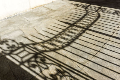 High angle view of shadow on tiled floor