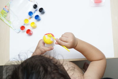 High angle view of boy playing with multi colored lights