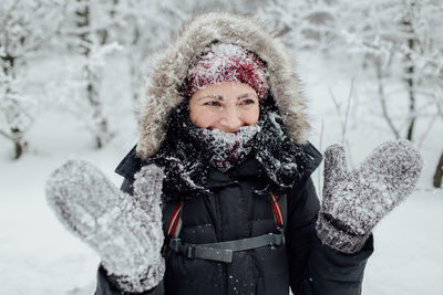 Woman in warm clothing standing on mountain during winter