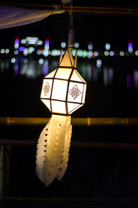 Close-up of illuminated pendant lights hanging from ceiling