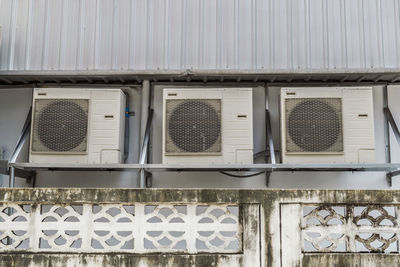 Low angle view of windows on wall of building