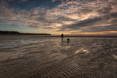 Scenic view of beach against sky during sunset