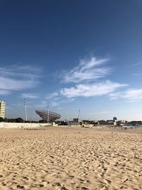 Scenic view of beach against blue sky