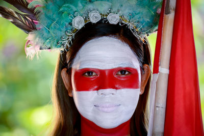 Portrait of woman wearing red mask