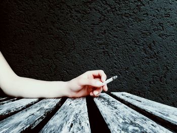 Close-up of hand holding cigarette