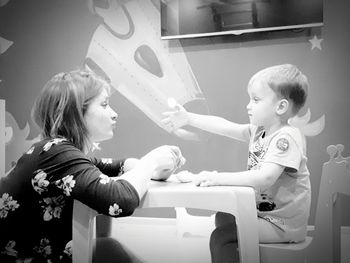 Woman with son sitting at table