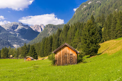 Scenic view of built structure on grassy field