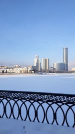 City by sea against clear blue sky