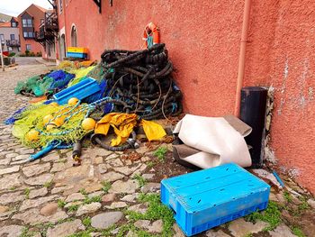 Garbage can against building wall