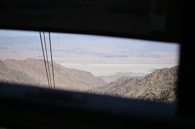 Scenic view of mountains seen through window