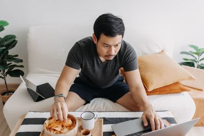 Young woman using laptop at home